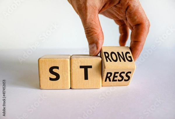 Fototapeta Strong stress symbol. Businessman turns wooden cubes with words 'strong stress'. Beautiful white background, copy space. Business and strong stress concept.