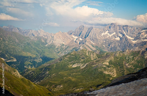 Obraz Beautiful view of snow-capped mountains and clouds over beautiful green valleys
