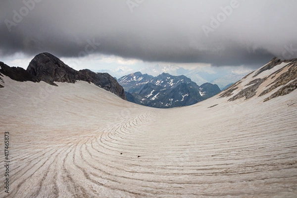 Obraz Panoramic view of a glacier with snow-capped mountains in the background
