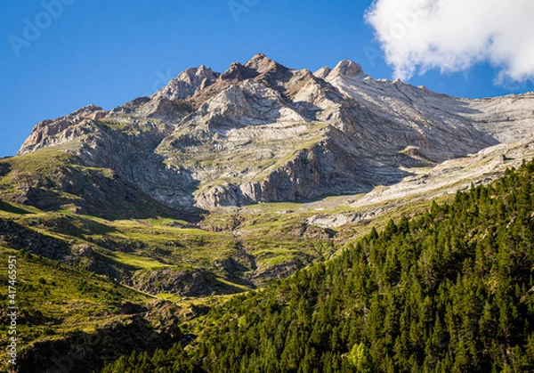 Obraz Impressive mountain in summer surrounded by green meadows with forests and steep walls