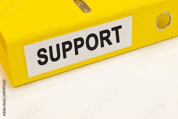 Fototapeta The word support on a white background with a yellow folder. Business concept
