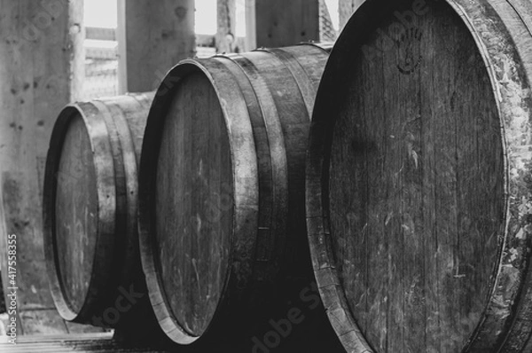 Obraz Abstract black and white view of three wooden barrels in row