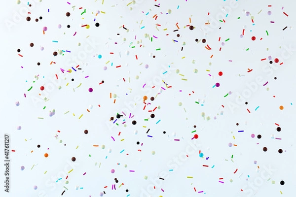 Fototapeta Abstract flying colorful pastry sprinkles on white background. 3d render illustration.