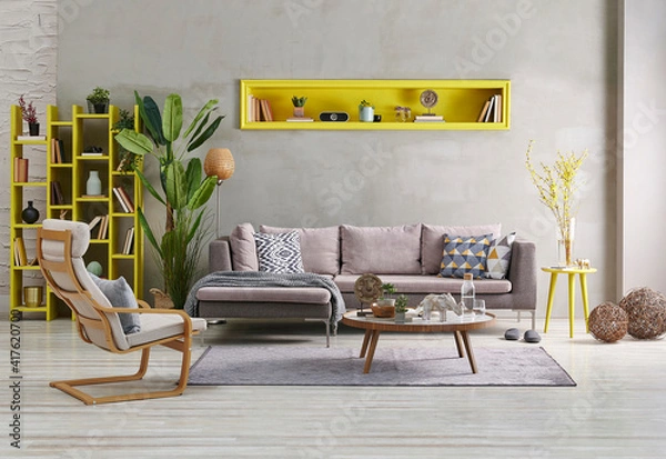 Fototapeta Decorative grey sofa and wall background stone style. yellow niche, home accessory, yellow bookshelf concept, poster frame orange lamp decor.