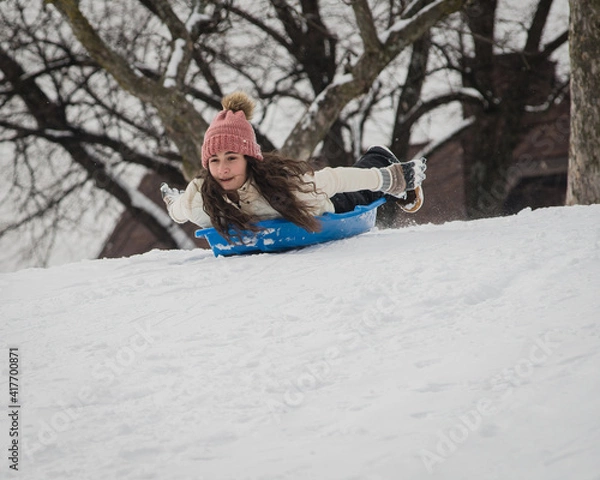 Obraz Girl sledding down hill