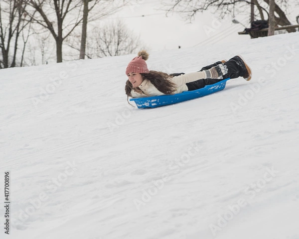 Obraz Girl sledding down hill