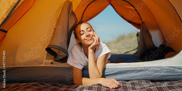 Fototapeta Dreamy lazy woman feeling good and enjoys free camping life during summer vacation.