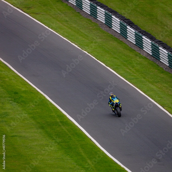 Fototapeta A shot of a racing motorbike as it circuits a track.