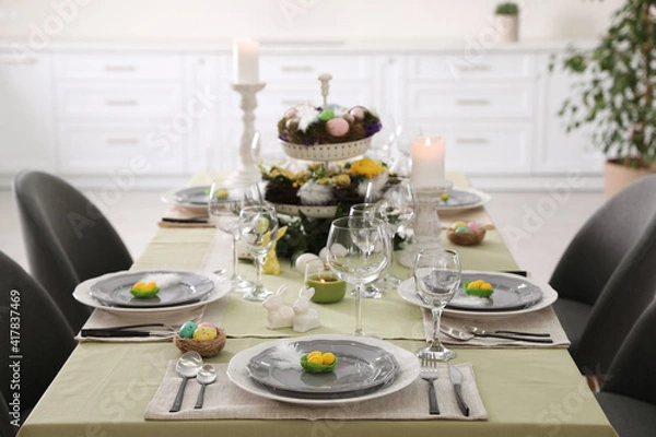 Fototapeta Beautiful Easter table setting with burning candles indoors