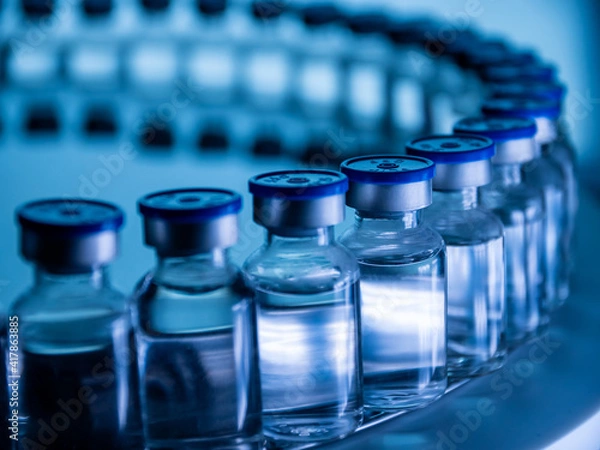 Fototapeta Group of Vaccine bottles. Medicine in ampoules. Glass vials for liquid samples in laboratory.