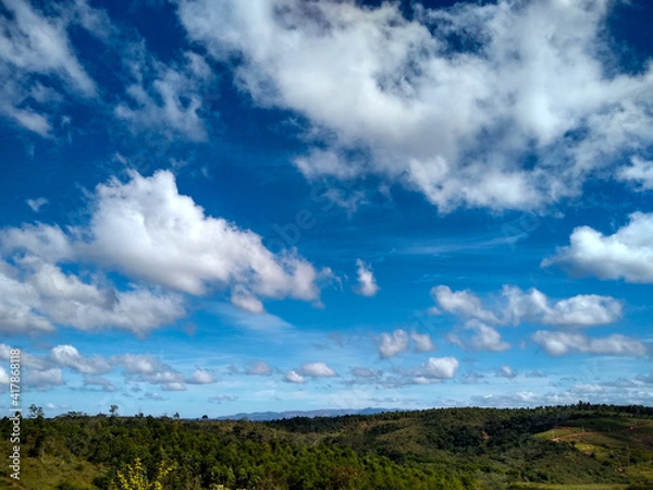 Fototapeta clouds over the field