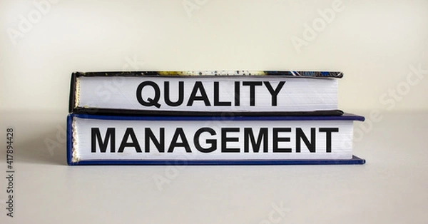 Fototapeta Quality management symbol. Concept words 'Quality management' on books on a beautiful white table, white background. Business and quality management concept.