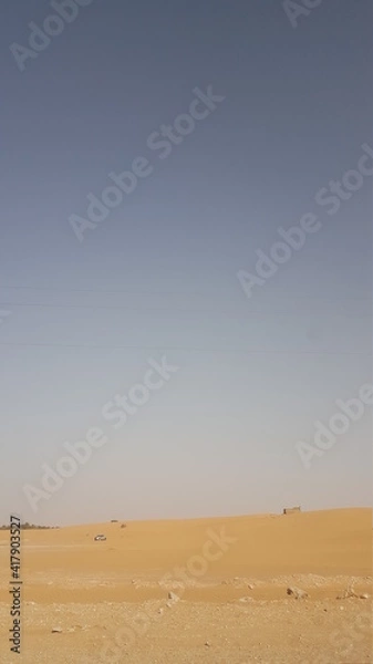 Fototapeta car in sand dunes in the desert