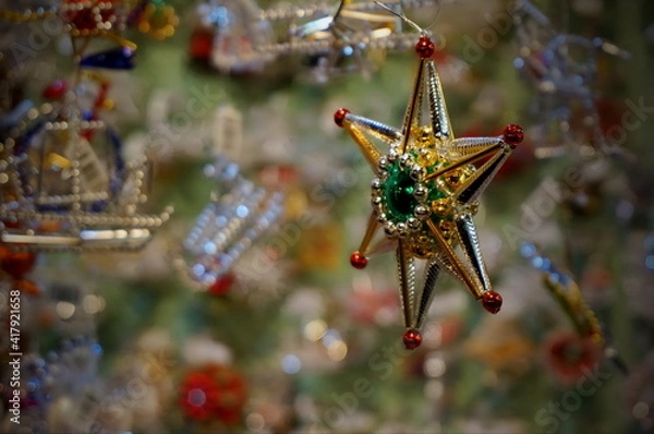 Obraz Close up photo of a small Christmas decoration in the shape of star, made of beads