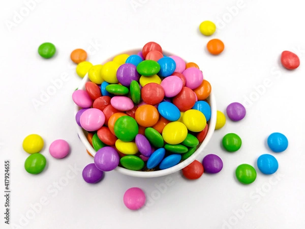 Obraz Bright multi colour chocolate gemes on white background