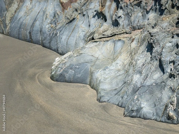 Fototapeta Rocks with straight edges on a beach
