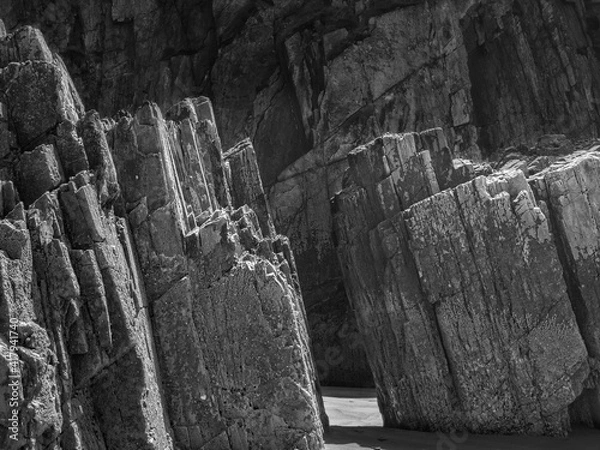 Fototapeta Rocks with straight edges on a beach