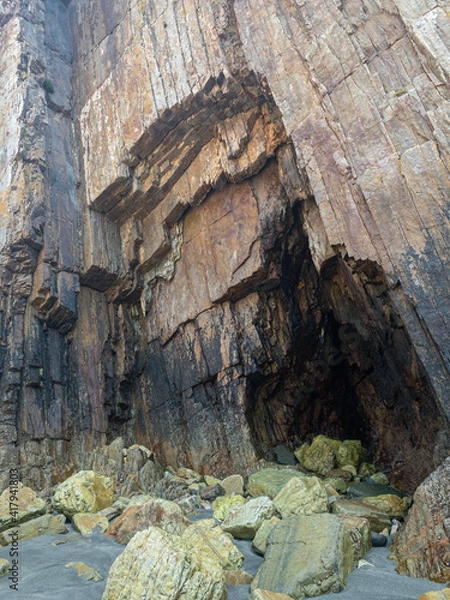 Fototapeta Rocks with straight edges on a beach