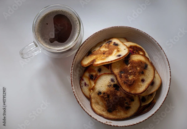 Obraz pancakes with berries in a plate. Coffee in a transparent cup. Breakfast

