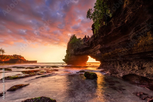 Fototapeta Dramatic Sunset color at Batu Bolong temple and Tanah Lot, Tabanan, Bali. beautiful view with the coral reef in low tide.