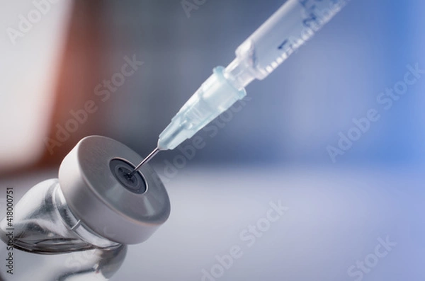 Fototapeta Syringe with liquid vaccines on table in laboratory,Concept covid-19 corona virus.