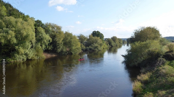 Fototapeta Reflection of trees in water along the river Wye.