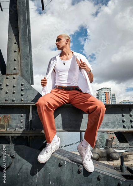 Obraz man sitting on a crane