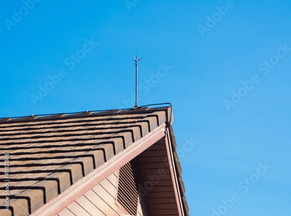 Fototapeta lightning rod for lightning protection is installed on the roof of the house.