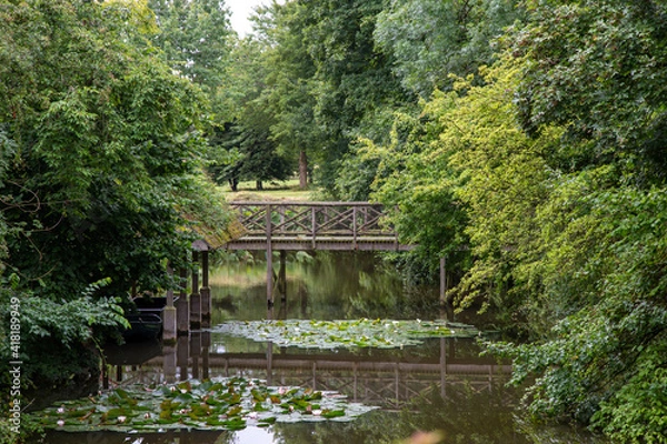 Fototapeta an old bridge over a lake in the countryside