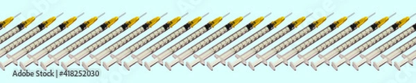 Fototapeta Banner Pattern of medical syringes for vaccination against the virus on a blue background