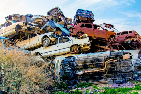 Obraz Pile of colorful discarded cars on junkyard