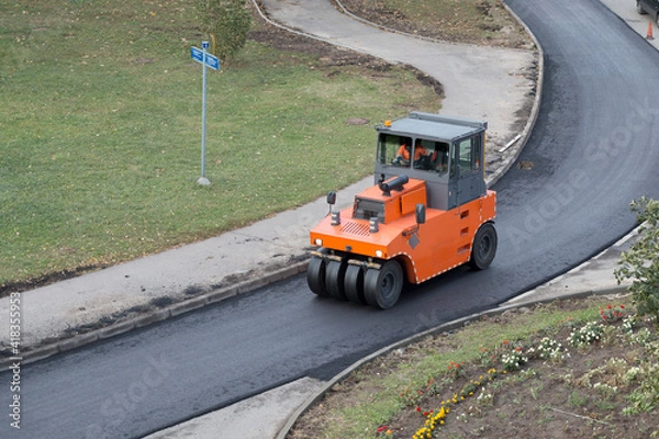 Obraz Roller compactor during operation. Road renewal process, compacting asphalt. Road construction, asphalt pavement works