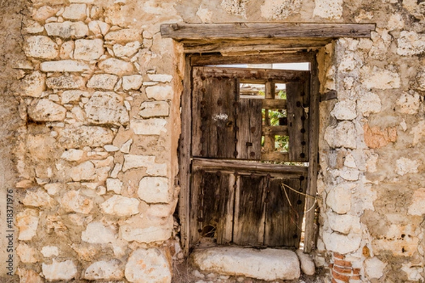 Fototapeta Ruin house wall window texture retro background. A dirty ancient urban abandoned home with broken wooden windows 