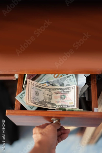 Obraz US banknote in drawer with opening hand