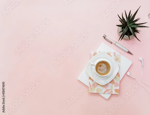 Obraz Pastel office desk table with notebook, coffee and supplies. Top view with copy space, flat lay.