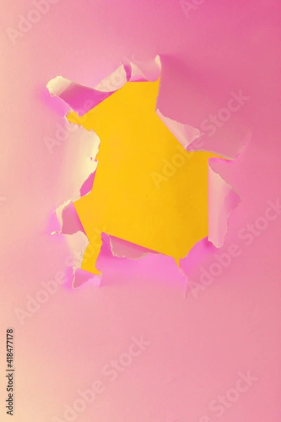 Fototapeta Ripped torn yellow pink paper with hole in center with no people. Copy space for your promotional content, inscription or advertisement. Blank hole to insert object. Torn colored paper. Abstract shot.