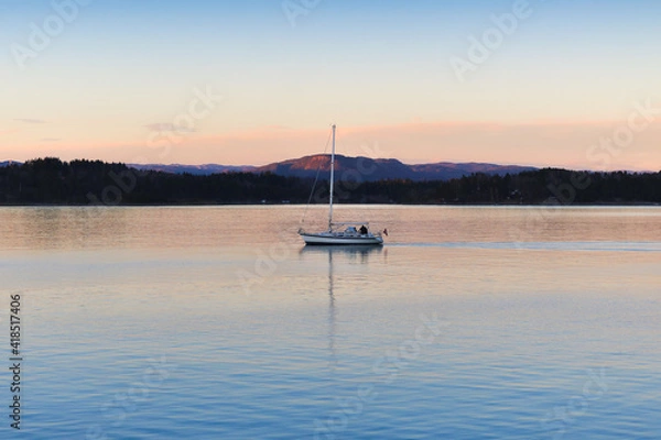 Obraz Boat out for a chilly sail at golden hour