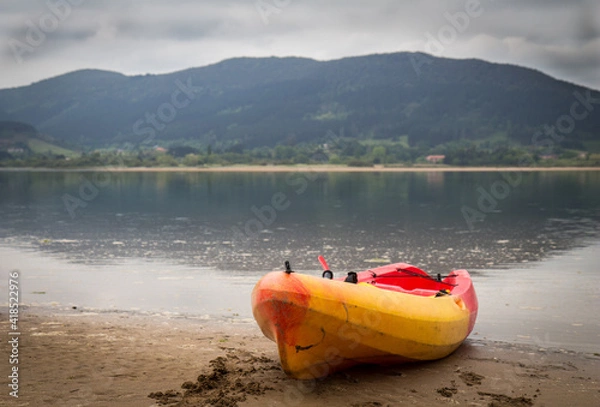 Obraz kayak on the shore of a quiet lake ready to use