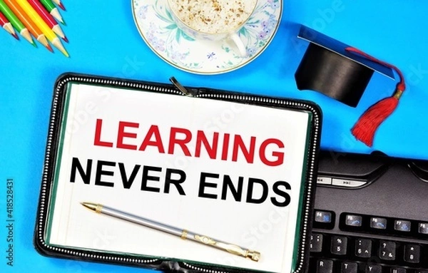 Fototapeta Learning never ends. A text label in the planning notebook. An opportunity to gain useful new knowledge. Commit to skills and abilities.