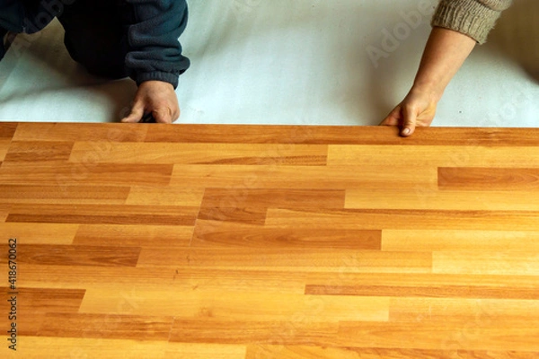 Fototapeta Installing laminate flooring in a room.