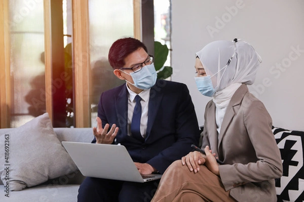 Fototapeta Business people relax working in co-working space, new normal and work anywhere while use laptop computer