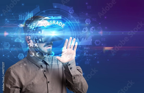 Fototapeta Businessman looking through Virtual Reality glasses with UPGRADE inscription, innovative technology concept