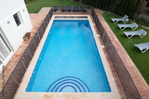 Fototapeta High angle view of a swimming pool with child safety fence around it
