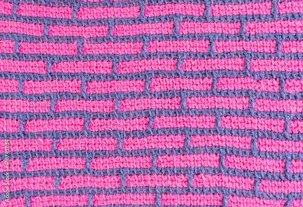 Fototapeta striped background of tunisian crochet fabric in basic stitch in pink with blue grid pattern