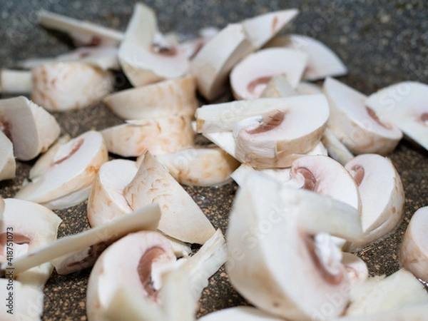 Fototapeta sliced raw mushrooms in a frying pan. cooking dinner.
