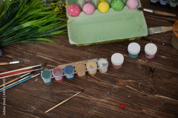 Fototapeta Table with paint and brush for painting easter eggs