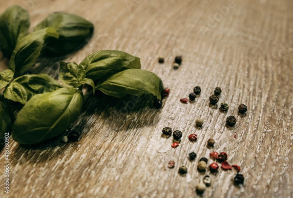 Fototapeta Basil leaves and sprinkled peppercorns