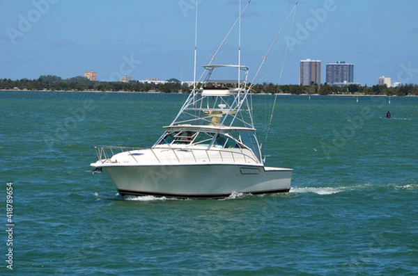 Fototapeta Sport fishing boat outfitted with a tuna tower cruising on the Florida intra-Coastal Waterway off of Miami Beach.