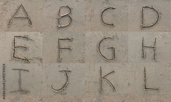 Fototapeta Character A B C D E F G H I J K L hand written on sand in evening