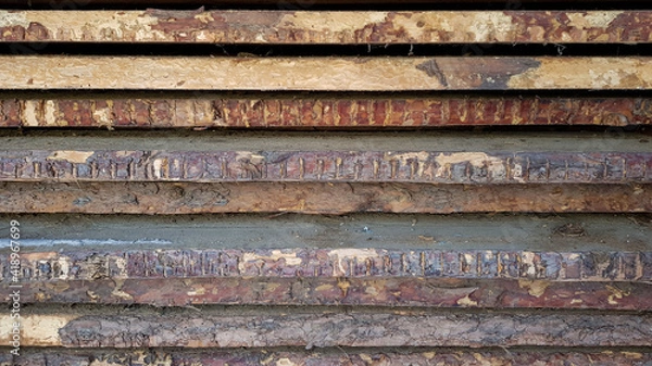 Fototapeta natural wooden boards stacked in a row on top of each other in a horizontal position as a background. decorative solution, shabby brown wooden planks with shabby bark. in the daytime, without people. 